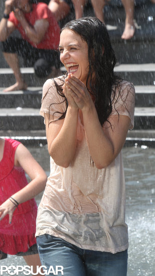 Katie Holmes laughed while splashing around on set in NYC.
Katie Holmes laughed while splashing around on set in NYC.