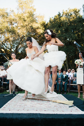African-American: Stepping Over the Broom
The custom of jumping over a broom symbolizes sweeping away the past and starting a home. The tradition began during slavery, when African-Americans were forbidden to marry and sealed their love with a leap. Today, brooms are often handmade as keepsakes.
Photo by Marianne Wilson via Style Me Pretty
African-American: Stepping Over the Broom
The custom of jumping over a broom symbolizes sweeping away the past and starting a home. The tradition began during slavery, when African-Americans were forbidden to marry and sealed their love with a leap. Today, brooms are often handmade as keepsakes.
Photo by Marianne Wilson via Style Me Pretty