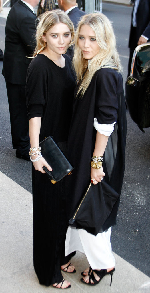 Twinning combo: Stacks of bracelets, slick black clutches, and strappy sandals? Check! The girls were ready to take on the big city in June 2007.
Ashley added a dash of dazzle to her black-on-black look with three diamond bracelets.
Mary-Kate layered an oversize black jacket over her white maxi, then slipped on a few animal bangles for the final touch.
Twinning combo: Stacks of bracelets, slick black clutches, and strappy sandals? Check! The girls were ready to take on the big city in June 2007.
Ashley added a dash of dazzle to her black-on-black look with three diamond bracelets.
Mary-Kate layered an oversize black jacket over her white maxi, then slipped on a few animal bangles for the final touch.