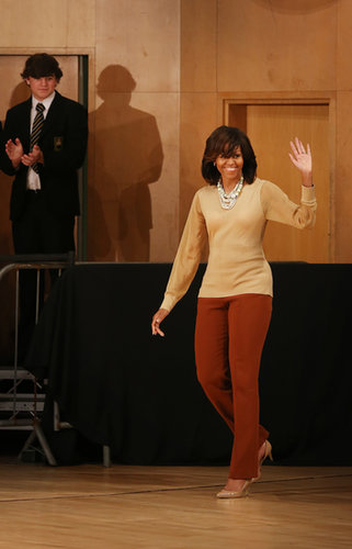 When she took off her Burberry coat, the First Lady revealed a nude sheer-sleeved blouse and rust-colored trousers at the G8 Summit in Northern Ireland.
When she took off her Burberry coat, the First Lady revealed a nude sheer-sleeved blouse and rust-colored trousers at the G8 Summit in Northern Ireland.