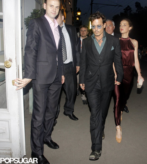 Johnny Depp held hands with Amber Heard in Moscow. Amber is carrying a Nancy Gonzalez clutch.
Johnny Depp held hands with Amber Heard in Moscow. Amber is carrying a Nancy Gonzalez clutch.