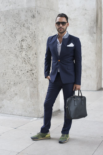 The staid navy suit feels personalized with a pocket square and trainers.
The staid navy suit feels personalized with a pocket square and trainers.