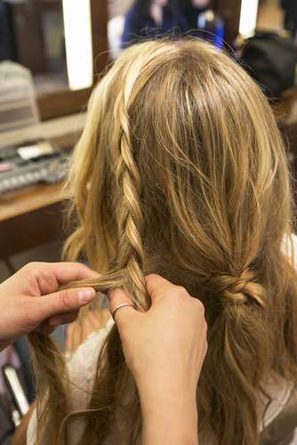 Gather the front left section of your hair and create an inside-out french braid (braid under rather than over) that goes to behind your ear. You can braid it tightly along your hairline, or a little bit looser like Guillen did here, depending on how you want your hair and braid to frame your face.
Gather the front left section of your hair and create an inside-out french braid (braid under rather than over) that goes to behind your ear. You can braid it tightly along your hairline, or a little bit looser like Guillen did here, depending on how you want your hair and braid to frame your face.