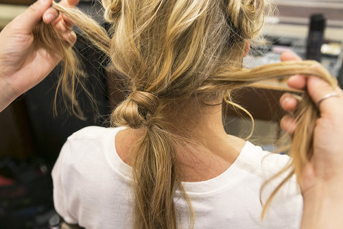 Now that you have the top of your look finished, it's time to revisit the loose ponytail and the hair along your neck. Split the loose hair underneath the ponytail into two even sections as shown here.
Now that you have the top of your look finished, it's time to revisit the loose ponytail and the hair along your neck. Split the loose hair underneath the ponytail into two even sections as shown here.