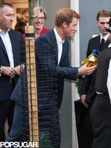 Prince Harry talked to a young woman, who handed him a gift.
Prince Harry talked to a young woman, who handed him a gift.