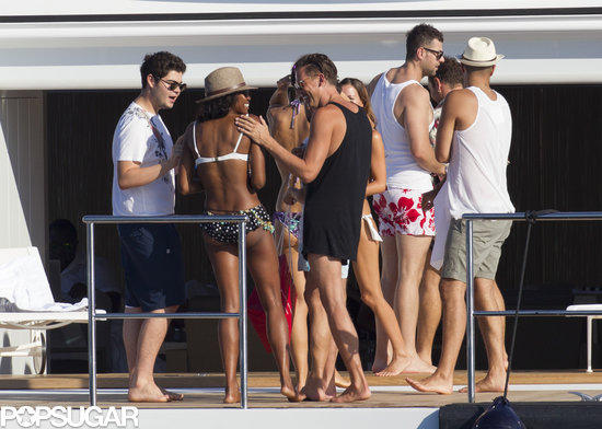 Naomi Campbell chatted with a large group of male friends.
Naomi Campbell chatted with a large group of male friends.