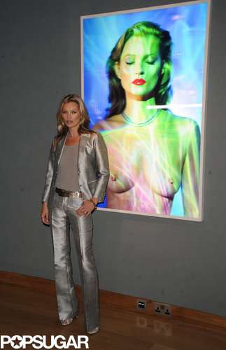 Kate Moss posed next to a topless photo of herself.
Kate Moss posed next to a topless photo of herself.
