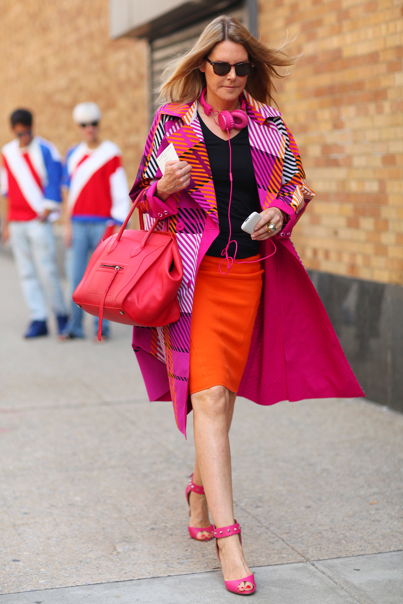 We can't get enough of her bright look — this showgoer embraced a bold colorwheel, even on her Céline tote.
