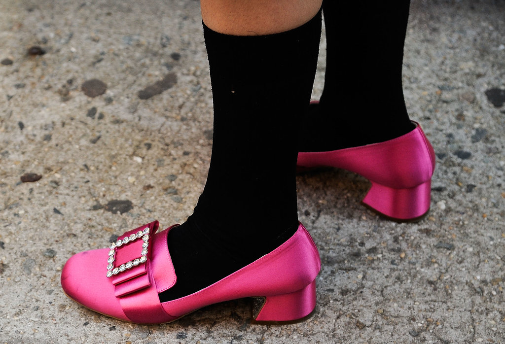 A stark contrast between her bright loafers and socks.
A stark contrast between her bright loafers and socks.
