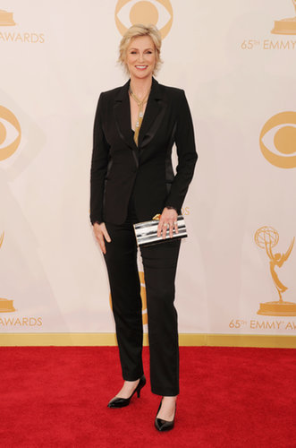 Jane Lynch completed a sharp suit with a pair of black kitten heels, bold gold jewels, and a striped clutch.
Jane Lynch completed a sharp suit with a pair of black kitten heels, bold gold jewels, and a striped clutch.