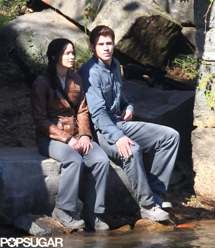 Jennifer Lawrence sat on a rock beside Liam Hemsworth.
Jennifer Lawrence sat on a rock beside Liam Hemsworth.