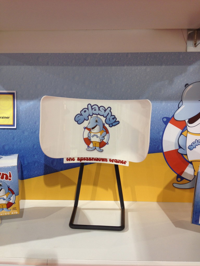 Splashy is a potty training aid that helps teach boys how to stand and pee. It prevents spray back on the seat and features a speaker that instructs boys to put the seat down.
