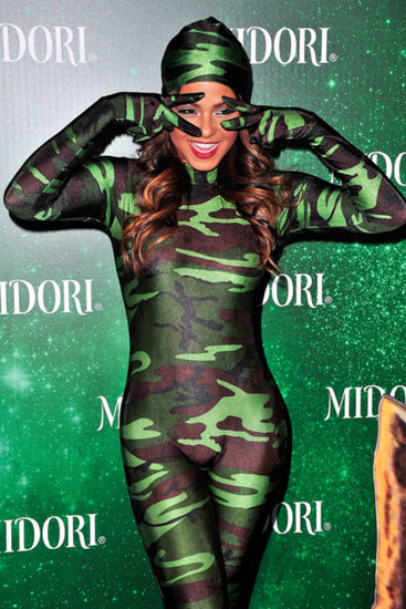 Christina Milian stood out at the Midori Green Halloween party in LA, despite wearing a camouflage ensemble.
Christina Milian stood out at the Midori Green Halloween party in LA, despite wearing a camouflage ensemble.