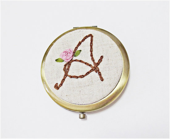 A cute compact gets an instant upgrade with a kitschy, embroidered mirror ($31).
A cute compact gets an instant upgrade with a kitschy, embroidered mirror ($31).