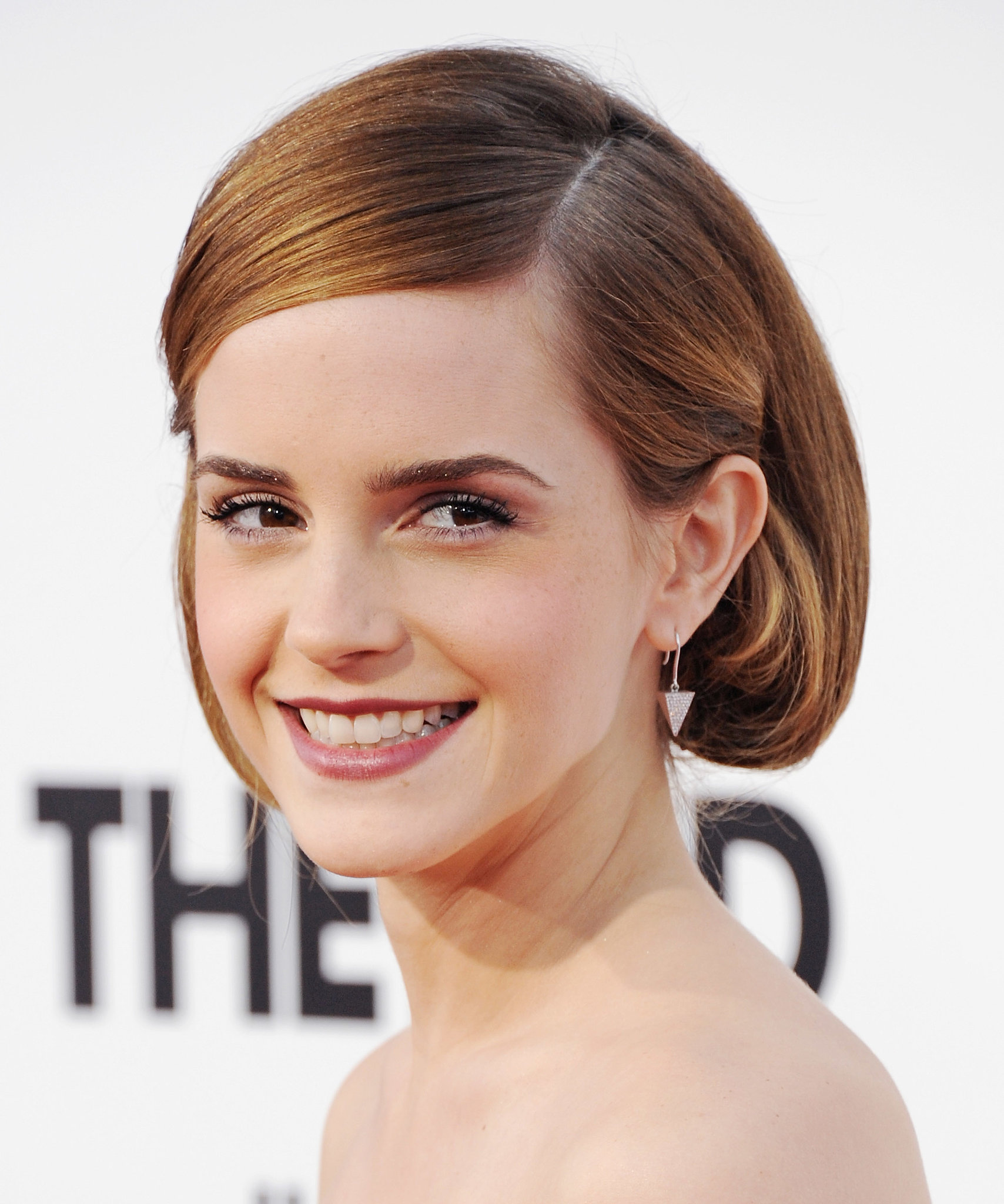 Sliding a bobby pin behind the ears of the shorter side of a deep 20