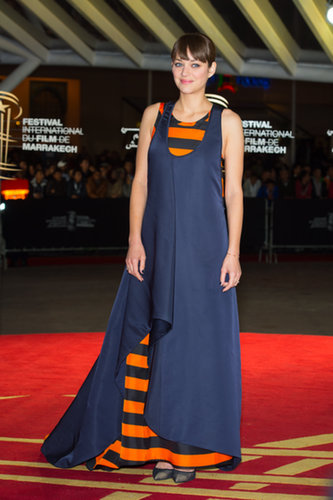 Marion Cotillard wore this Dior Haute Couture navy silk gown with a striped orange and black layer underneath to the premiere of Waltz With Monica at the Marrakech Film Festival.
Marion Cotillard wore this Dior Haute Couture navy silk gown with a striped orange and black layer underneath to the premiere of Waltz With Monica at the Marrakech Film Festival.