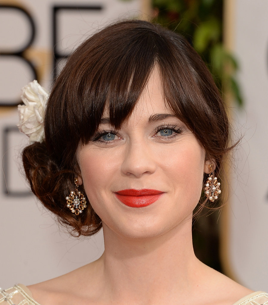 With a statement red lip and flower-adorned chignon, Zooey Deschanel stuck to her signature style for tonight's big show.
With a statement red lip and flower-adorned chignon, Zooey Deschanel stuck to her signature style for tonight's big show.