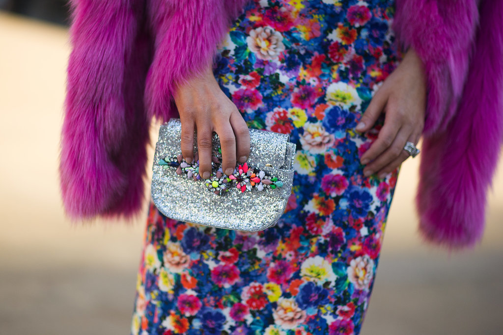 The multicolored embellishments on her clutch upped the ante on her rainbow-bright floral print. 
