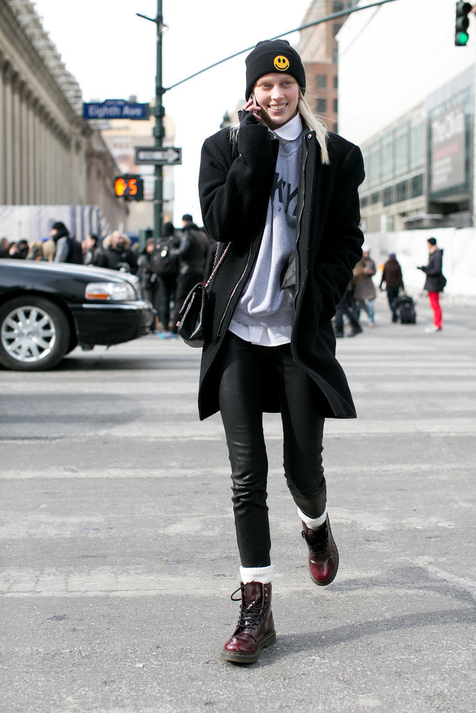 This model's kicking it old school with Doc Martens and a smiley-faced beanie. 
