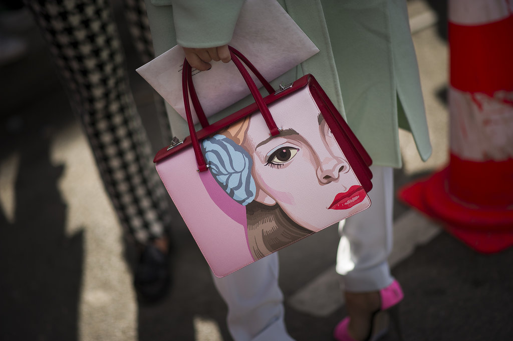 How do you really make a statement with your accessories? With a face-painted Prada bag.
How do you really make a statement with your accessories? With a face-painted Prada bag.