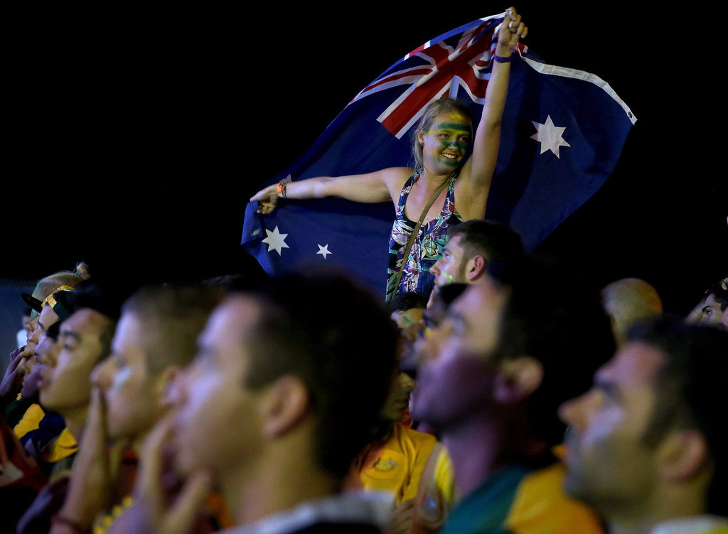 A fan waved her flag while watching the game between Australia and Chile.
A fan waved her flag while watching the game between Australia and Chile.