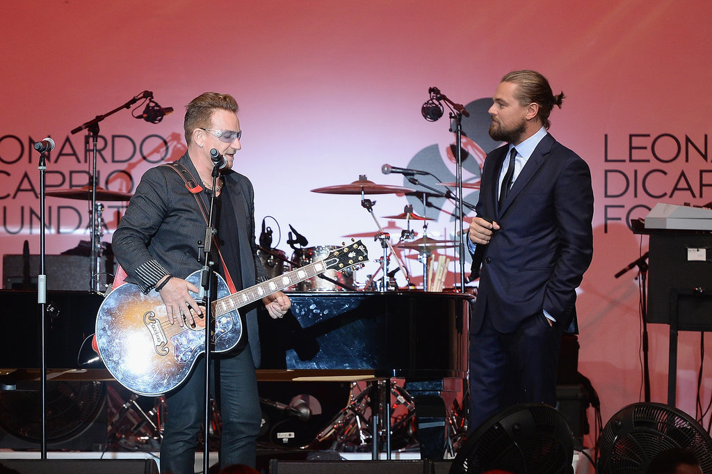 Leo watched as Bono played guitar.
