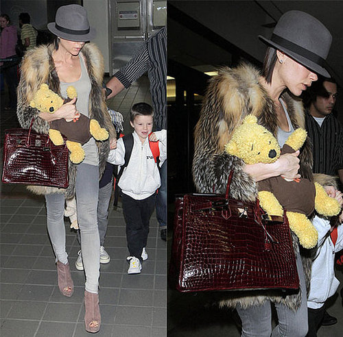 Victoria Beckham at LAX Wearing Fur Jacket and Fedora