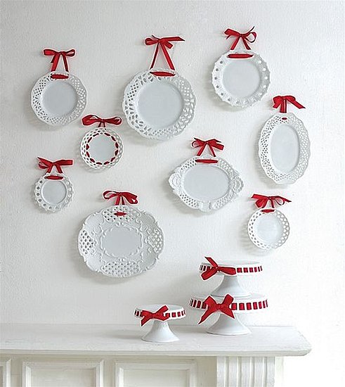 For a pretty touch, hang plates with ribbons. I love the way that a few of these lacy-edged plates have been threaded with the ribbon around the circumference of the plate. You can buy these plates here.
For a pretty touch, hang plates with ribbons. I love the way that a few of these lacy-edged plates have been threaded with the ribbon around the circumference of the plate. You can buy these plates here.