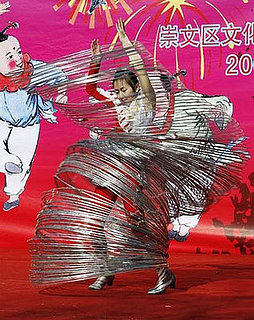 Woman Does Hula With a Giant Slinky