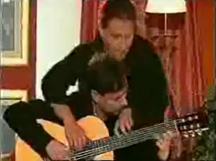 Two Men Play One Guitar