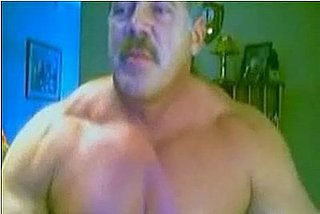 Muscle Man Admires Himself for the Camera