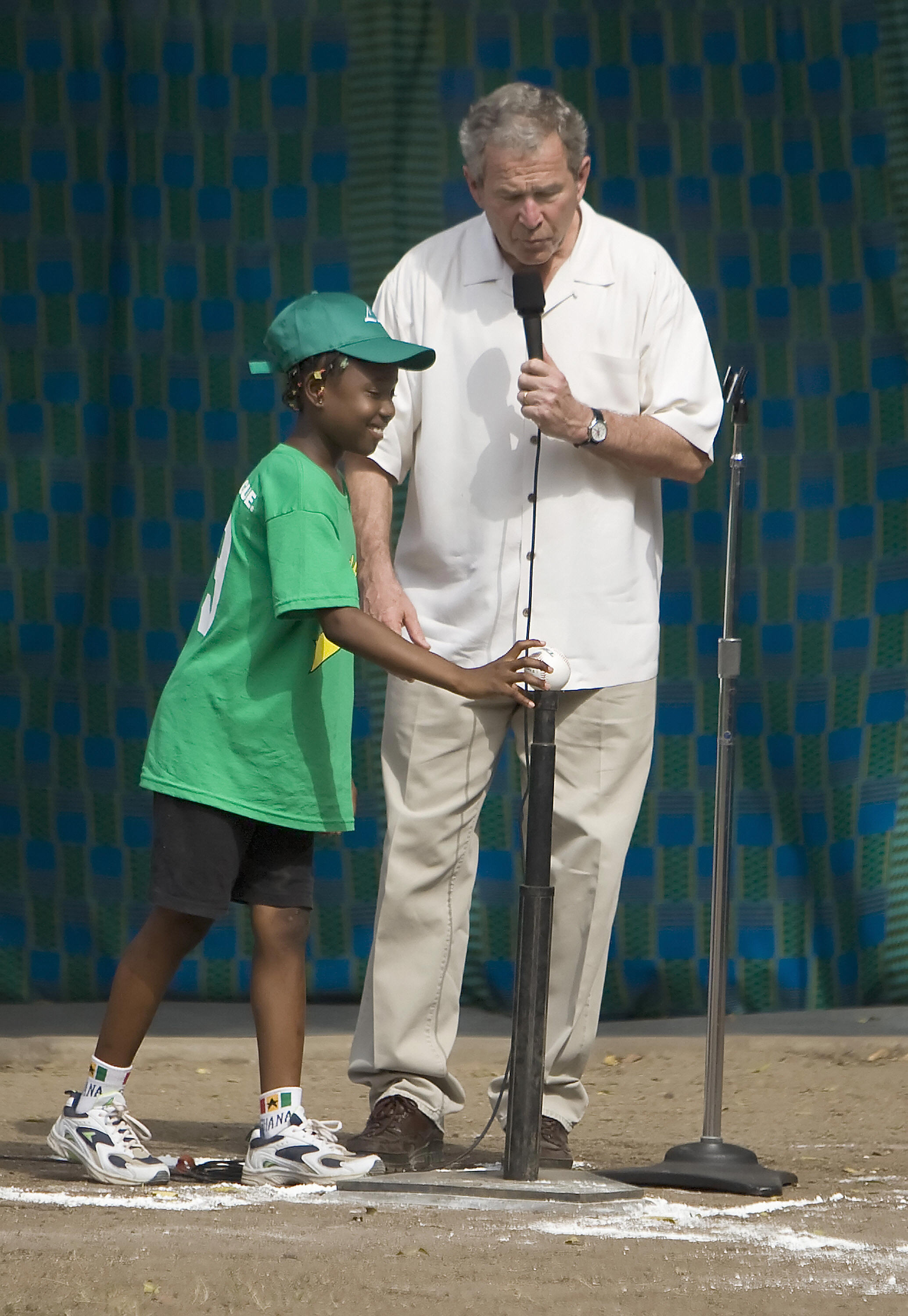 Bush starts a t-ball game in Ghana. Bush starts a t-ball game in Ghana.