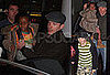 Photos of Guy Ritchie, Rocco Ritchie, and David Banda at London Gatwick Airport
