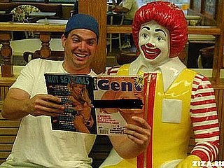 Man Poses With Ronald McDonald and Porn