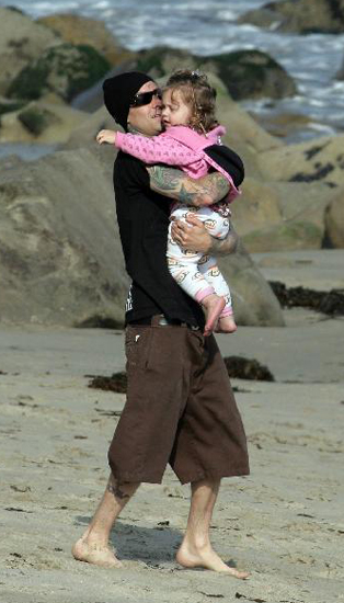 Travis Barker gave lil Alabama some lovin' on the beaches of Malibu. Travis Barker gave lil Alabama some lovin' on the beaches of Malibu.