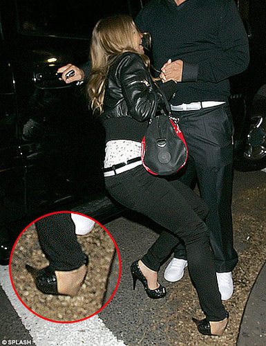Fall from grace: Fergie trips over in her towering heels