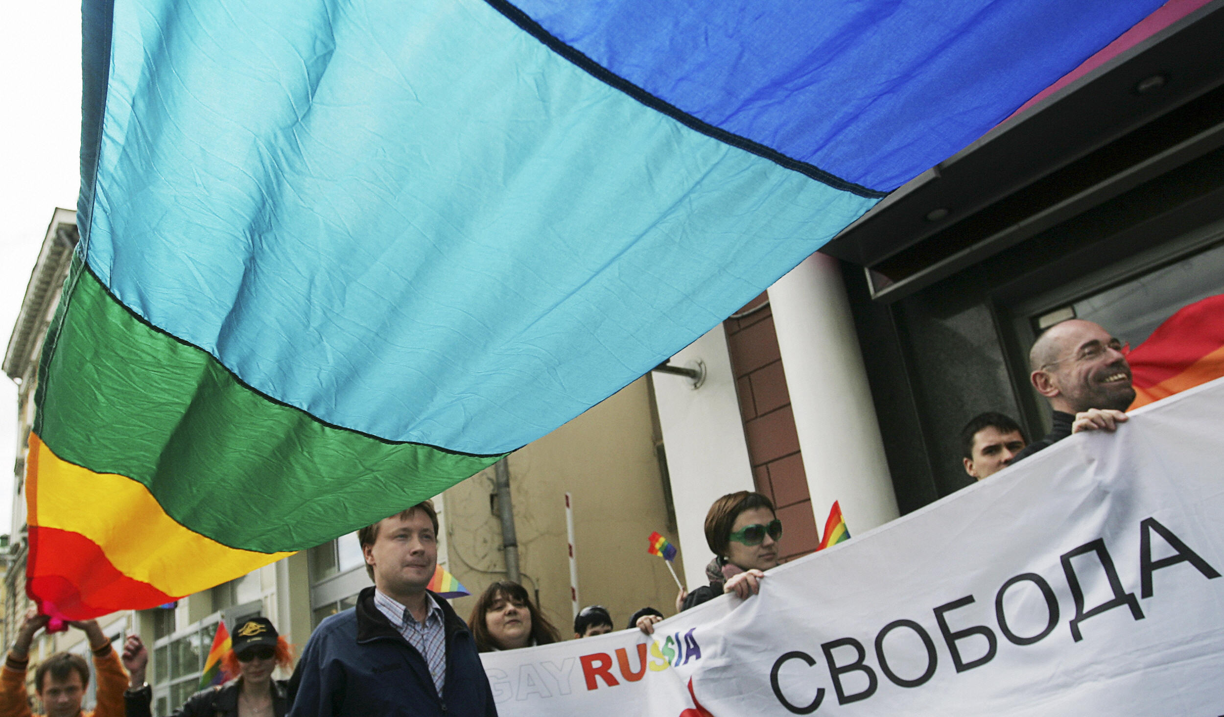 Members of the Russian gay community hold flags. Members of the Russian gay community hold flags.