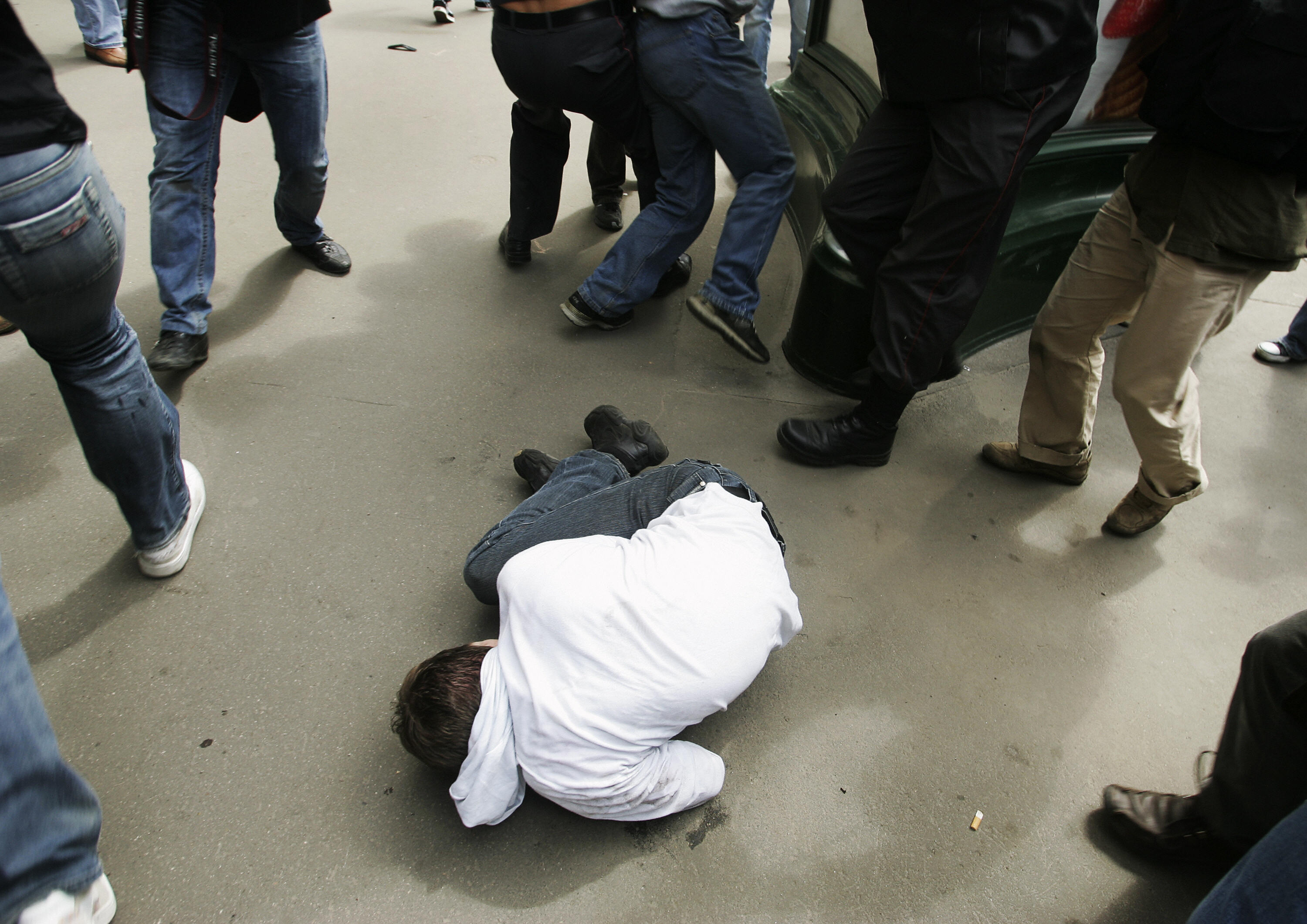 A member of the Russian gay community lies on a ground after he was beaten by a far-right activist. A member of the Russian gay community lies on a ground after he was beaten by a far-right activist.