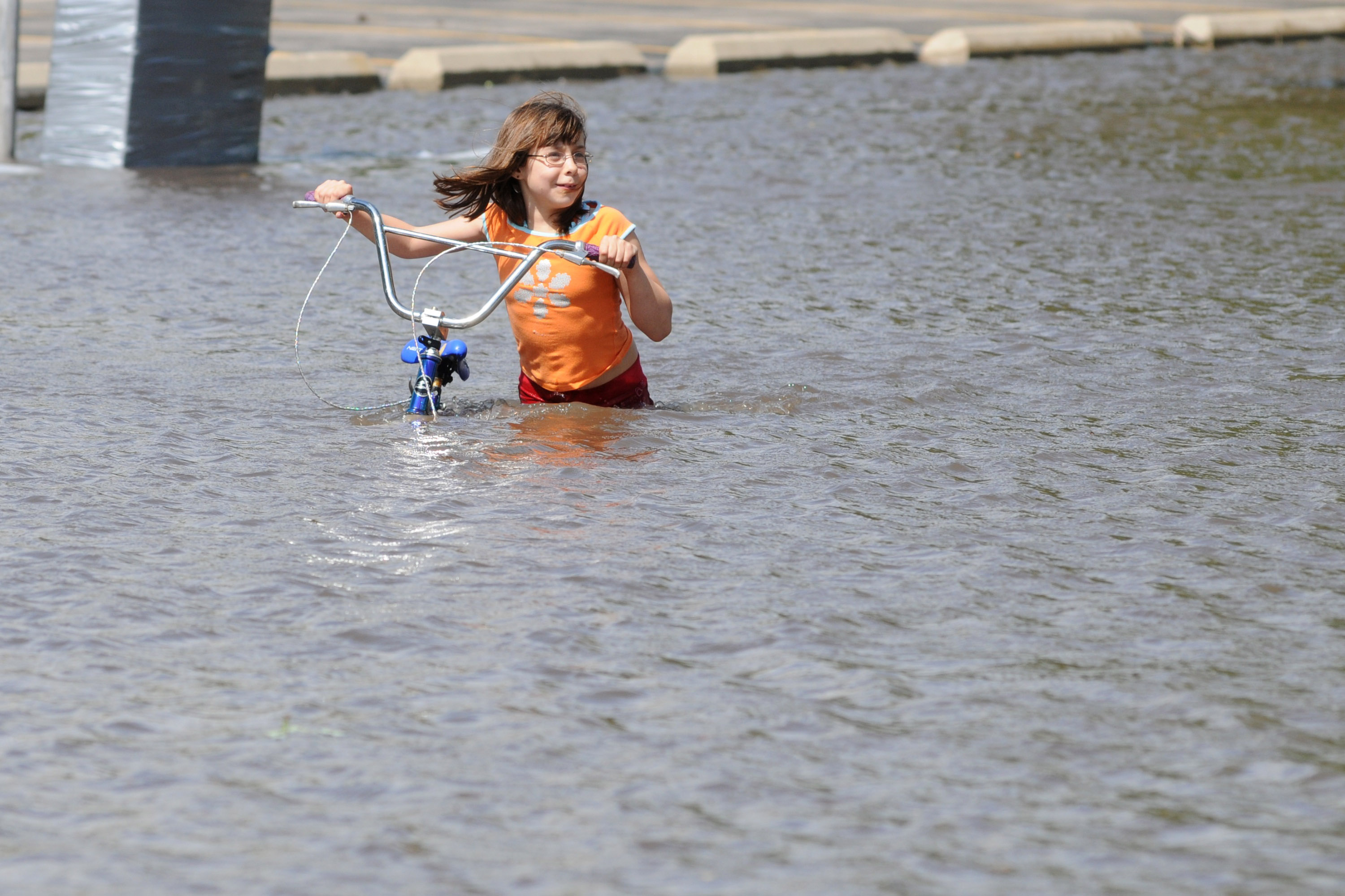 Gabrielle Steenblock, 8, walks across a flooded street near downtown Cedar Rapids. Gabrielle Steenblock, 8, walks across a flooded street near downtown Cedar Rapids.