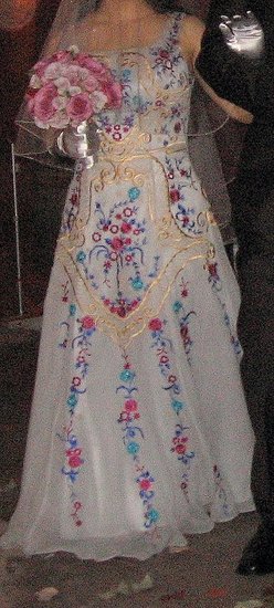 Platinum silk taffeta with embroidery in gold, platinum, fuschia, turquoise and cobalt blue. 