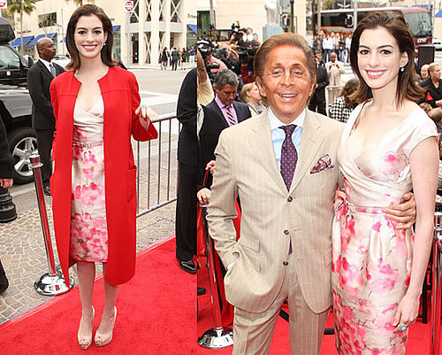 Anne Hathaway Helps Induct Valentino Into The Rodeo Drive Walk Of Style in a Floral Pink Dress and Red Coat