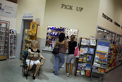 Customers Talk on Their Cell Phones While Getting Prescriptions Filled